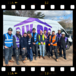 The DIY SOS team and members of Prism Medical UK standing in front of the DIY SOS van.