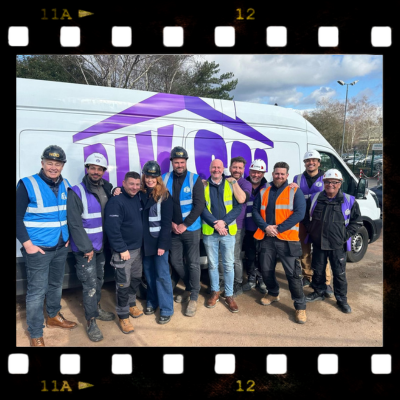 The DIY SOS team and members of Prism Medical UK standing in front of the DIY SOS van.